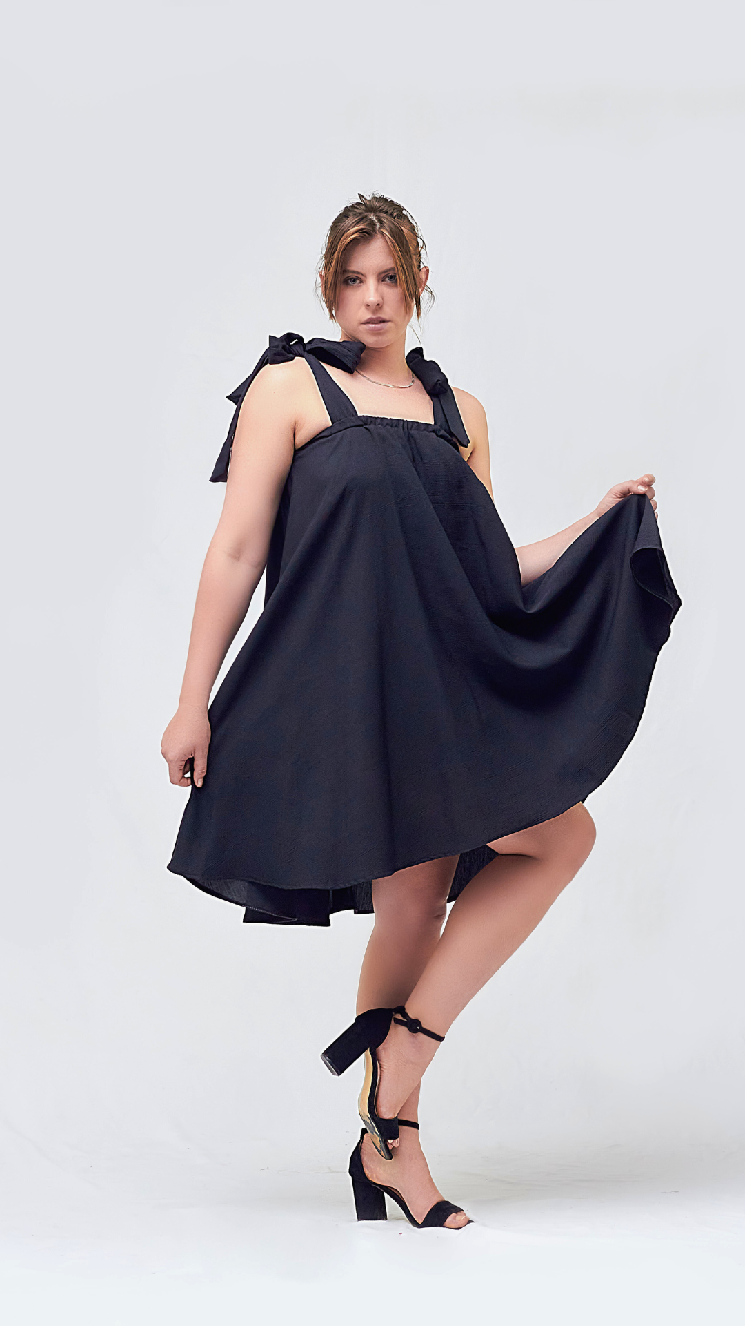 Front of a Black flare dress with shoulder ties